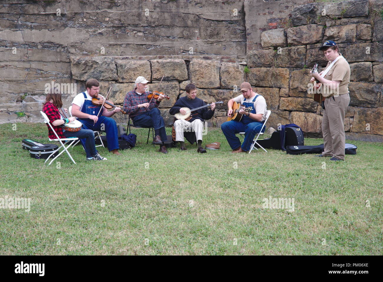 Six musicians play a tune together at a local folk music festival. Stock Photo