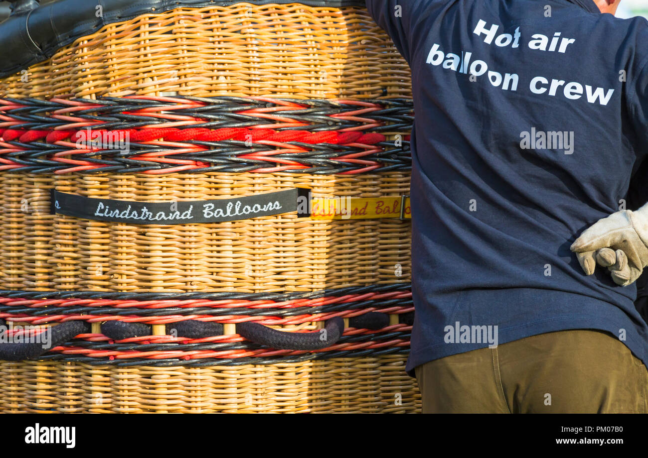 hot air balloon crew with basket preparing hot air balloon at Longleat Sky Safari, Wiltshire, UK in September Stock Photo