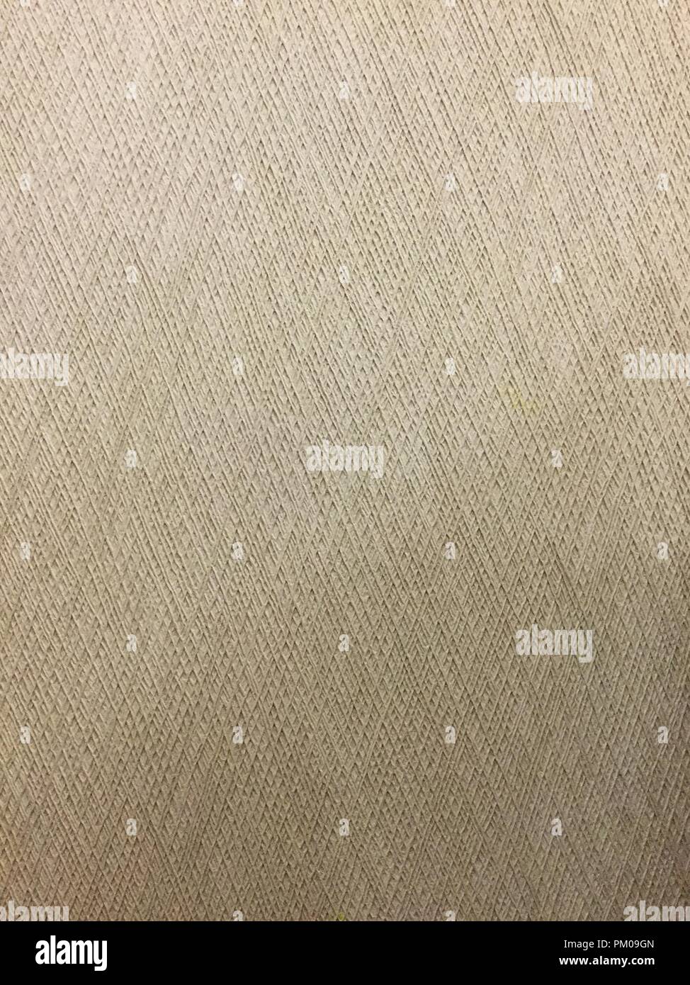 Beige wall covering with rough textures and designs. Stock Photo