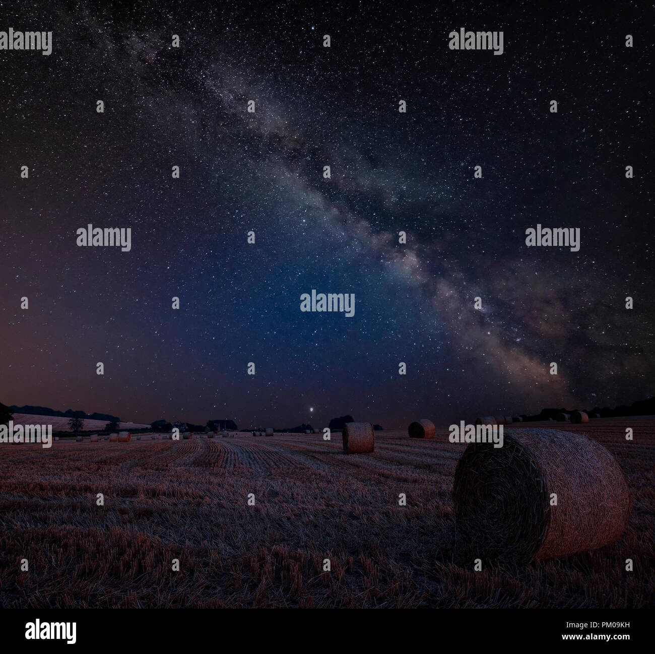 Stunning vibrant Milky Way composite image over landscape of Lovely hay ...