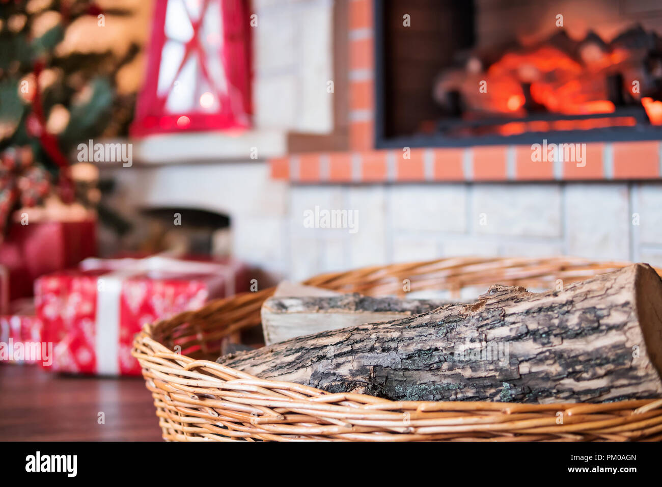 Pine Wood In The Basket In Front Of The Burning Fireplace Stock
