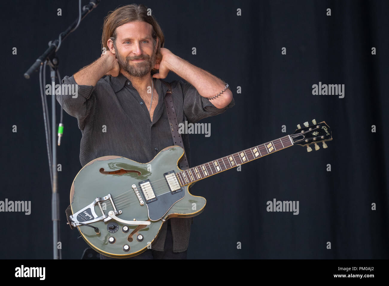 American actor Bradley Cooper filming scenes for his New film A Star Is Born  on the Pyramid stage at Glastonbury festival 2017 Stock Photo - Alamy