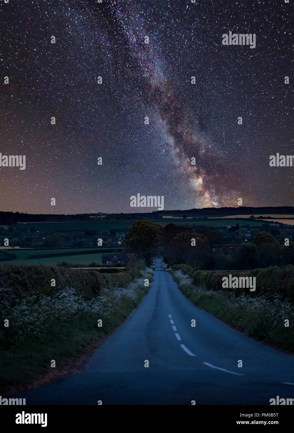 Stunning vibrant Milky Way composite image over landscape of empty road ...