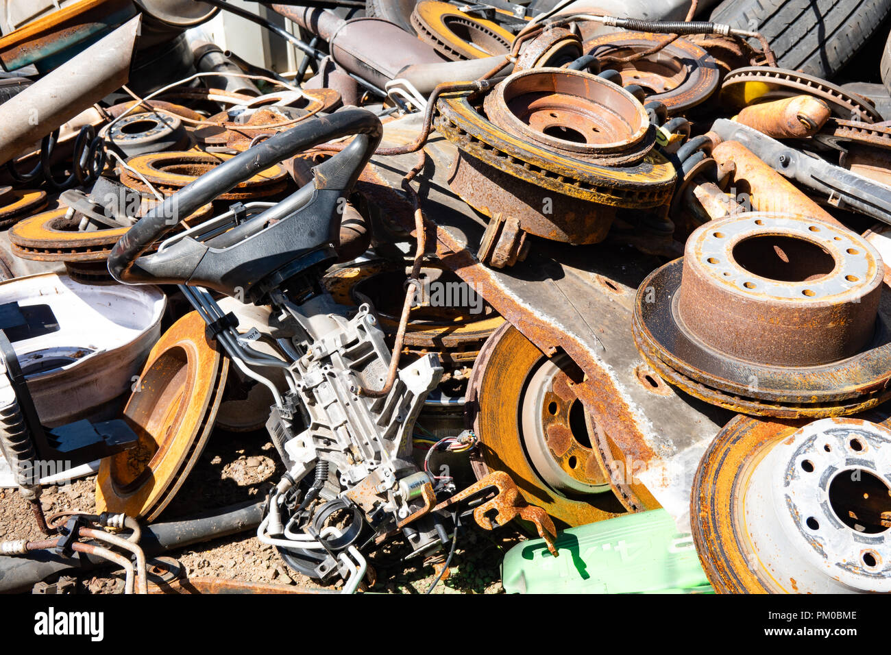 A pile of discarded used vehicle parts and tires for recycling in Upstate New York, USA. Stock Photo