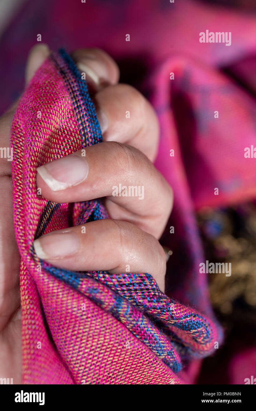 Blurred cashmere fabric hold in a woman's hand Stock Photo