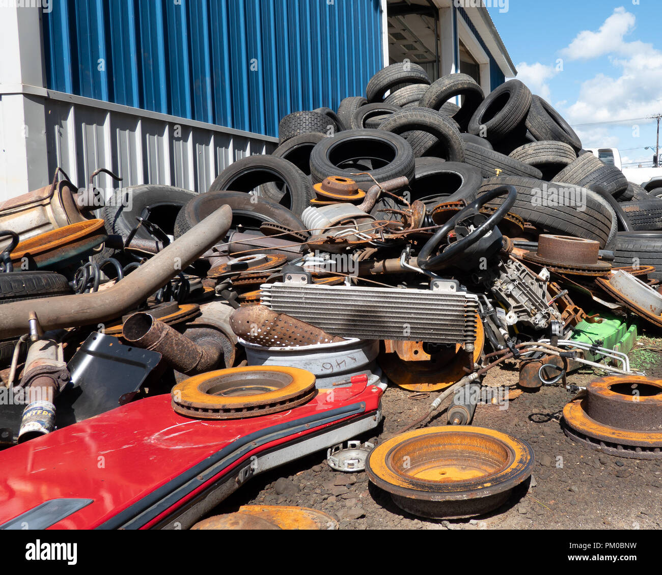 A pile of discarded used vehicle parts and tires for recycling in Upstate New York, USA. Stock Photo