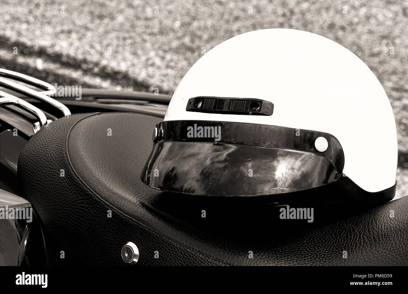 Closeup of motorcycle headlights, helmet in black and white Stock Photo