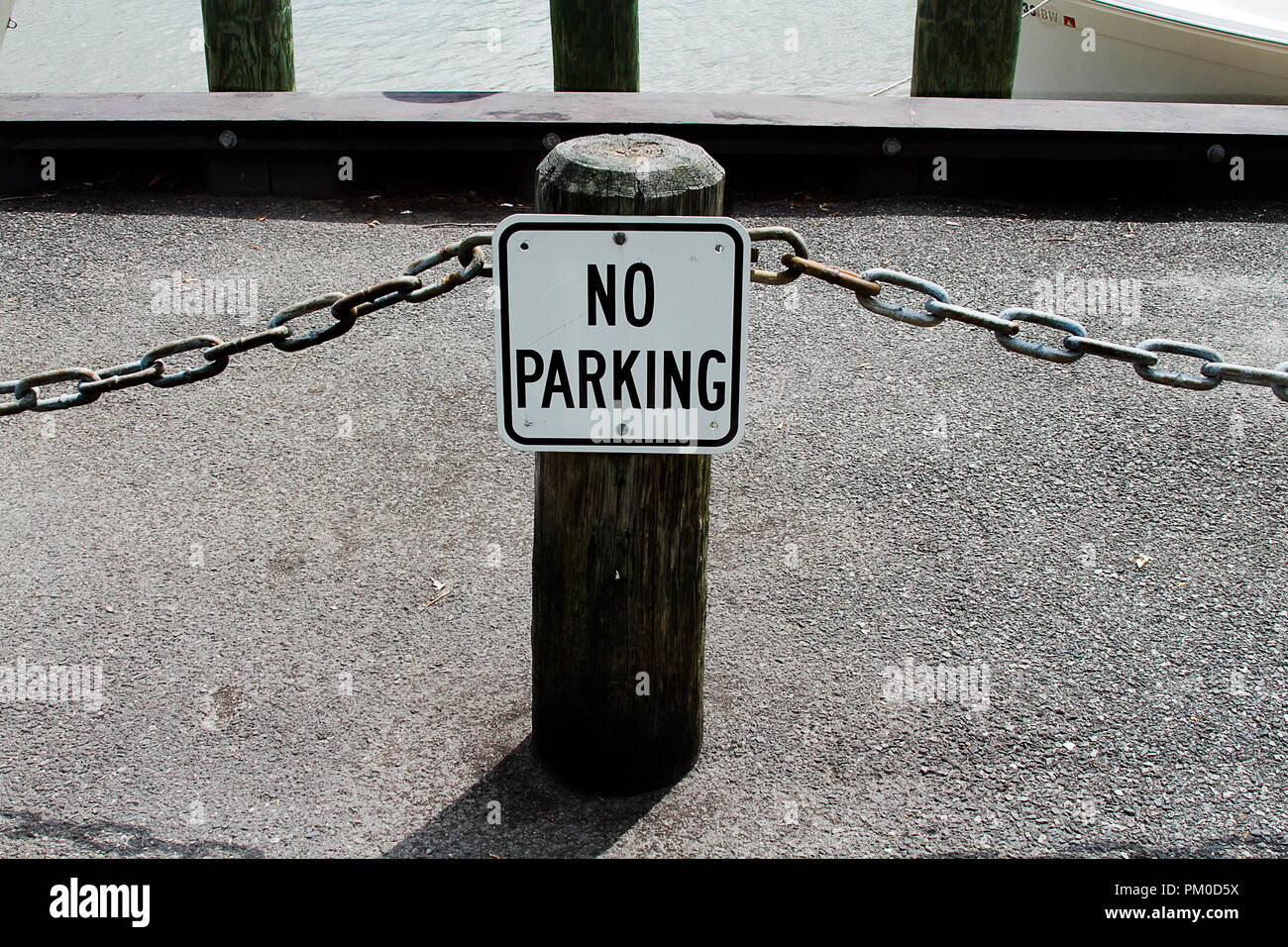 No Parking sign with chain blocking parking Stock Photo Alamy