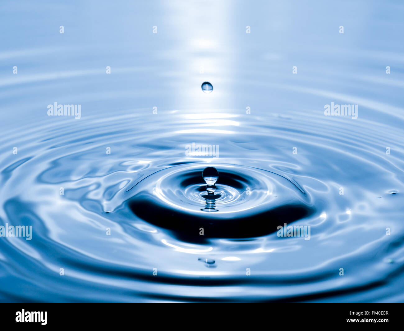 close up drop of water on blue background Stock Photo - Alamy