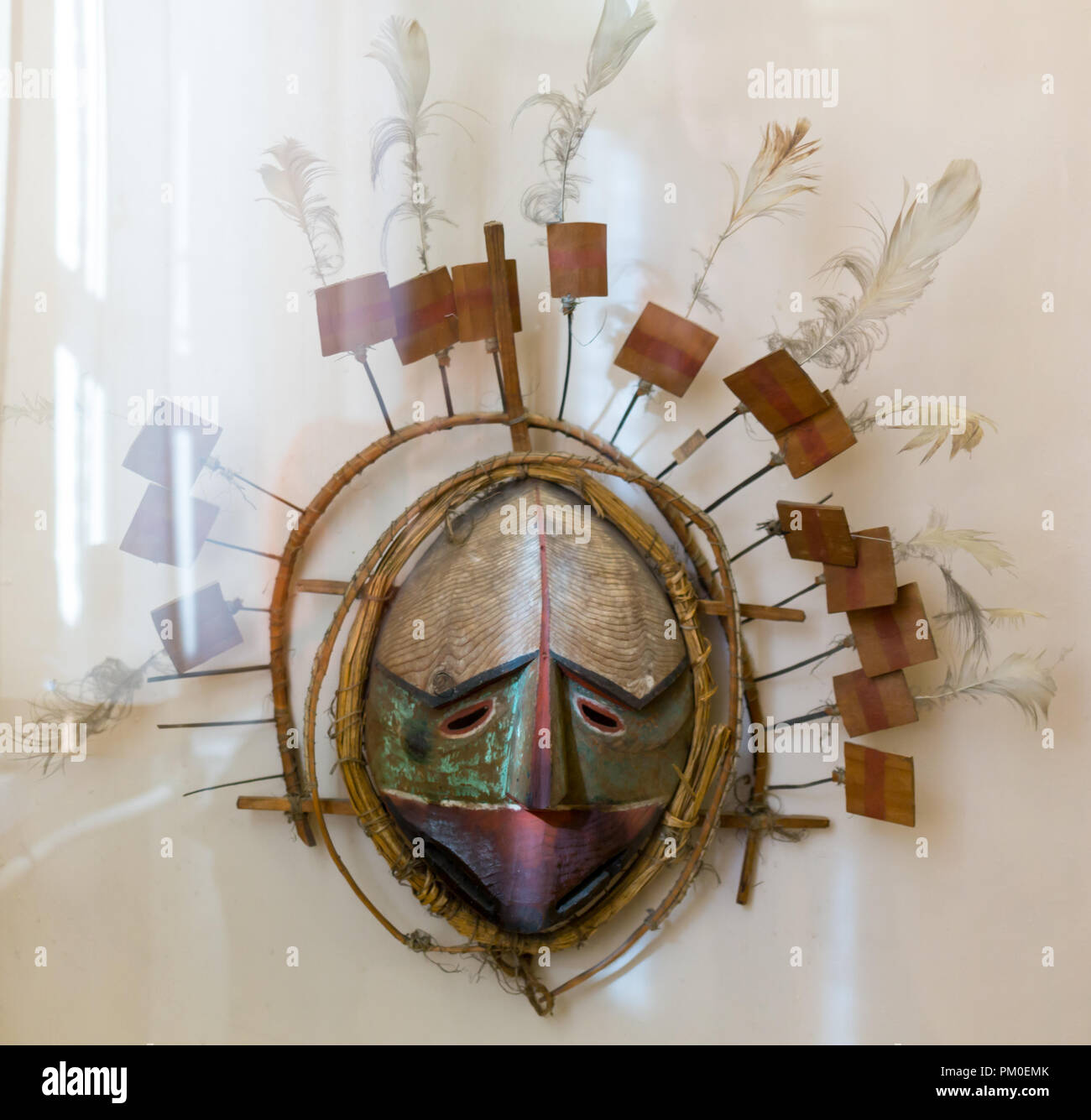 Mask ritual from a tree, decorated with paints on a white background ...