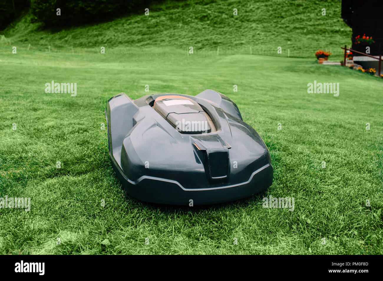 Robotic lawn mower on grass, automated lawn mower Stock Photo