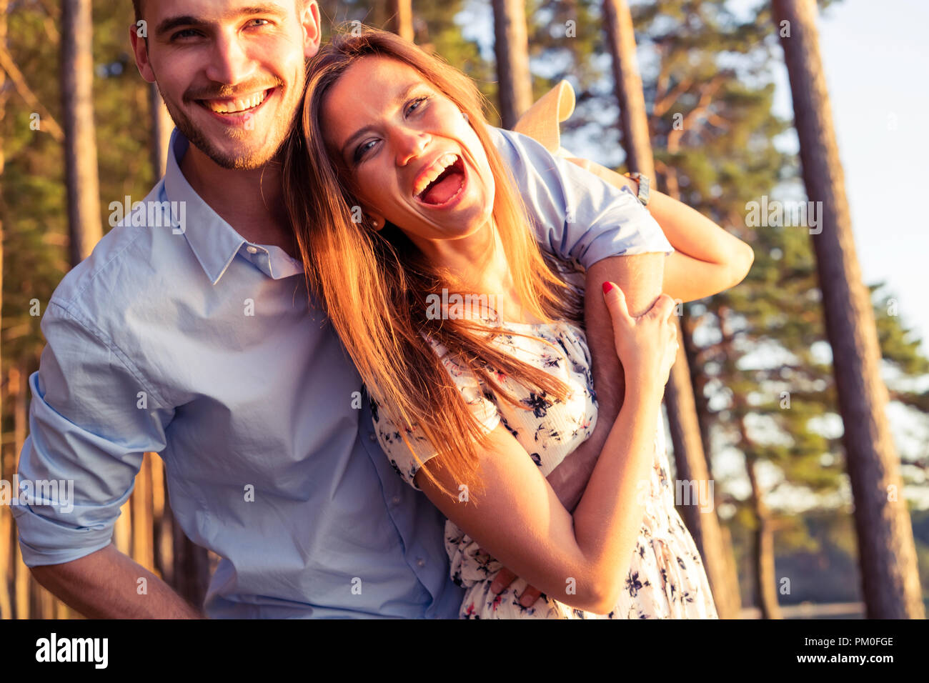 Happy couple in love having fun outdoors and smiling Stock Photo - Alamy
