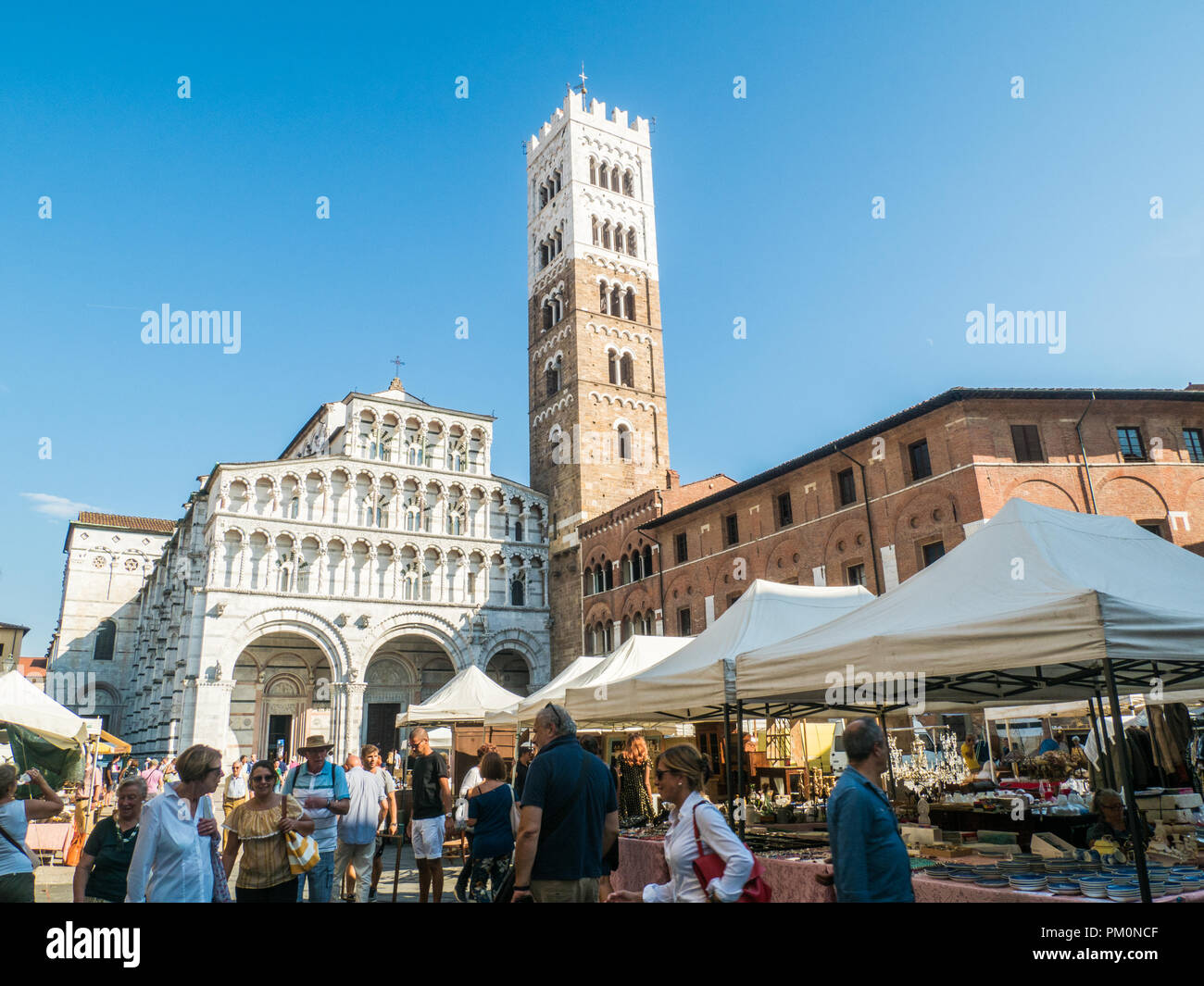 Cathedral of St Martin (San Martino), Piazza Antelminelli, on a market day in the walled city of Cathedral of St Martin (San Martino), Piazza Antelminelli, on a market day in the walled city of