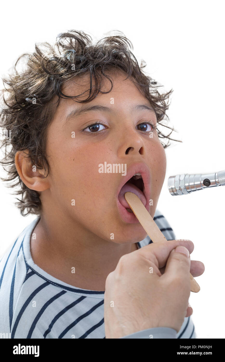 teen boy medical examination.little boy having his throat examined by health professional Stock Photo