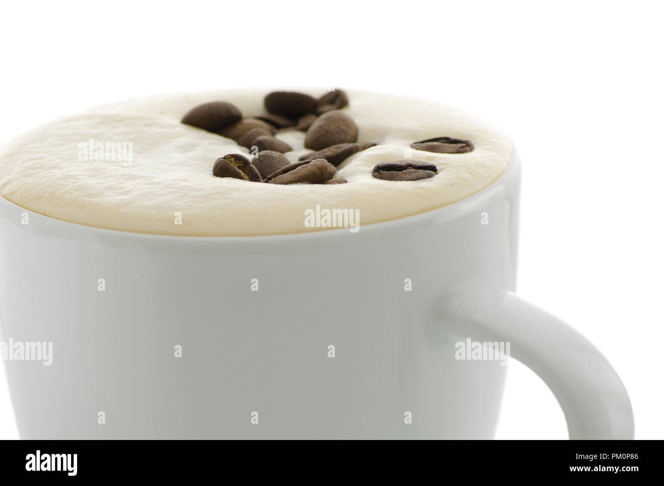 Closeup of coffee beans floating on top of coffee foam Stock Photo Alamy