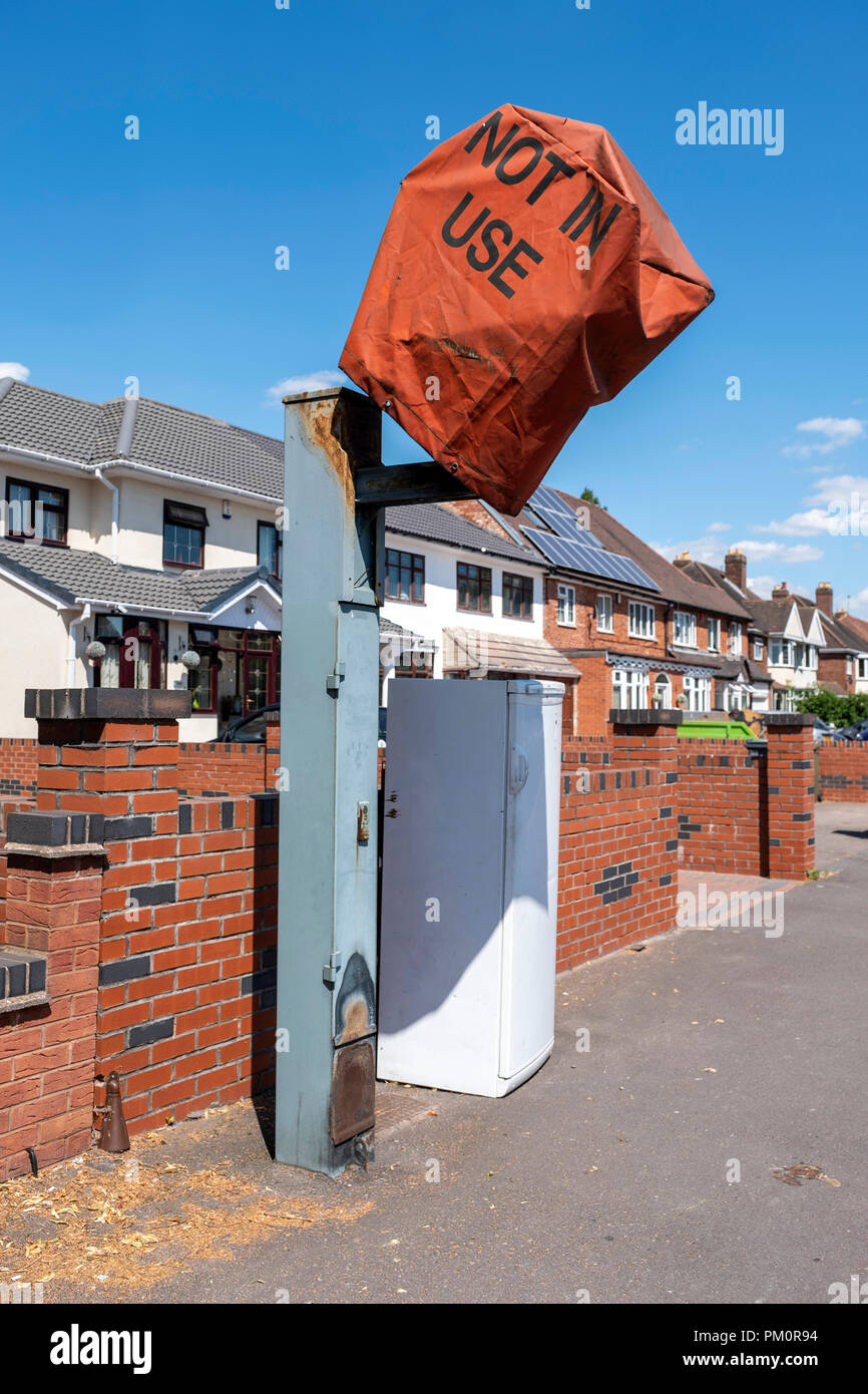 Fridge left by covered speed camera on street, West Midlands Stock Photo