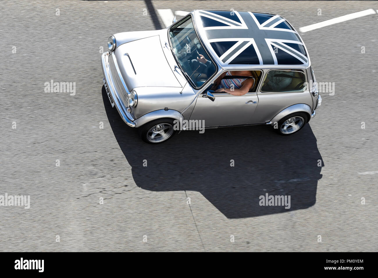 British Mini car driving on Southend seafront on a sunny day. Monochrome British Union Jack Flag roof design Stock Photo