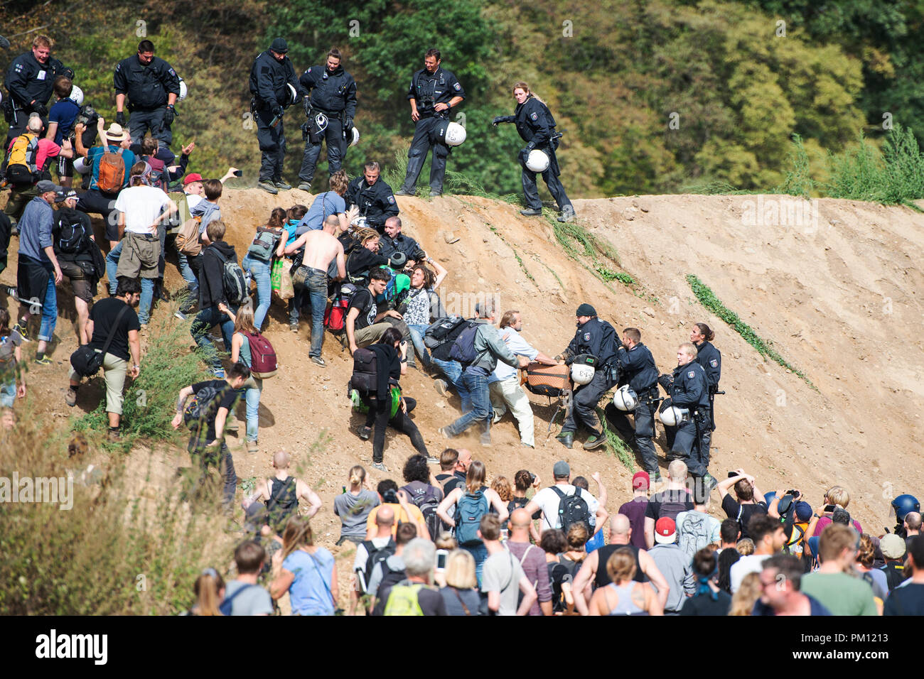 Kerpen, Germany. 16 September2018. Participants in a demonstration against the clearing of the Hambach forest trying to get into the forest via a wall and being held back by the police. Demonstrations by several thousand opponents of lignite have not been able to stop the further clearing of the Hambach forest over the weekend. Credit: dpa picture alliance/Alamy Live News Stock Photo