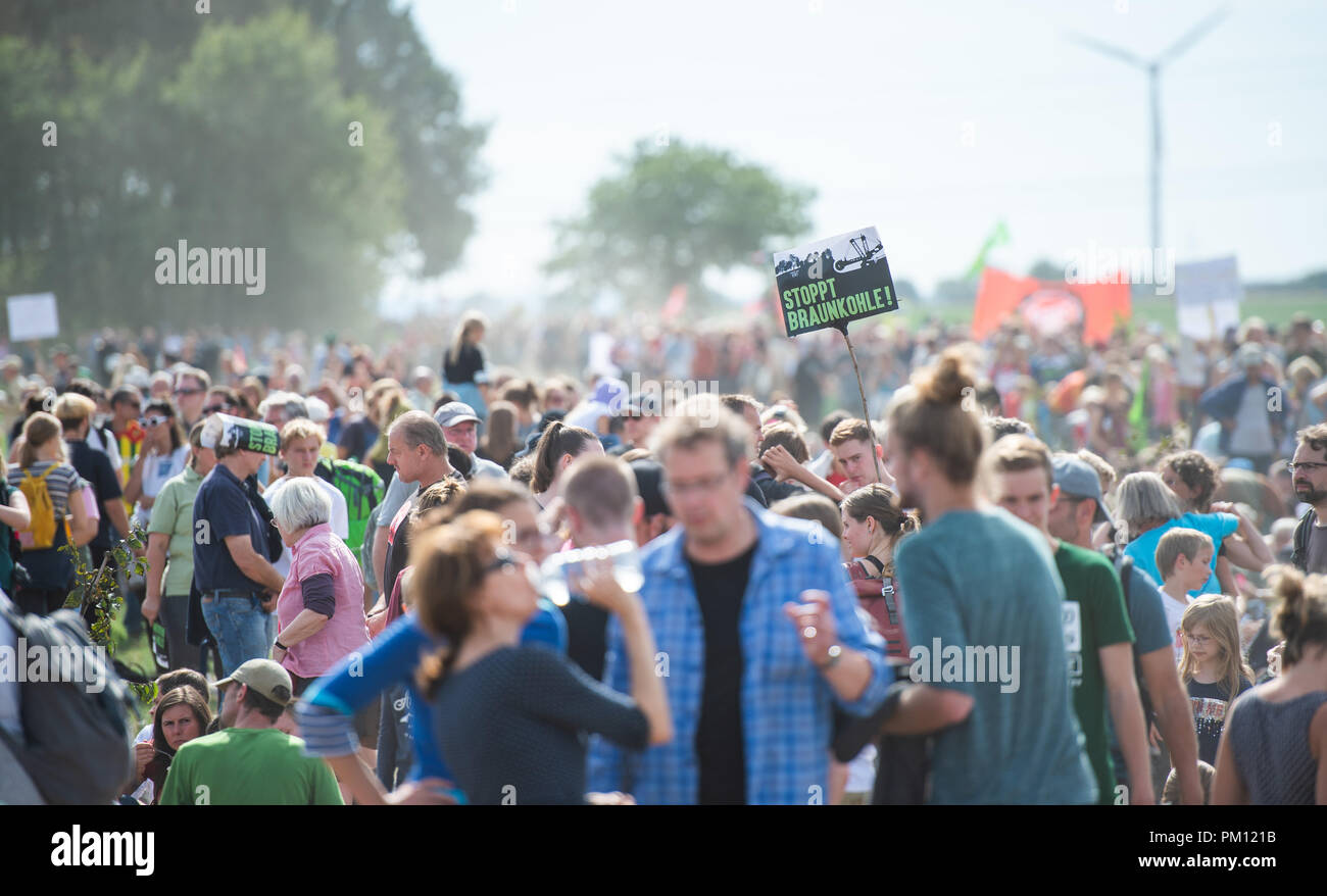 Kerpen, Germany. 16 September2018. Participants in a demonstration against the clearing of the forest walking across a field in the Hambach Forest. The demonstrators walked over fields and paths on the edge of the forest. Some carried young trees with them, which they wanted to plant in already cleared area. Demonstrations by several thousand opponents of lignite have not been able to stop the further clearing of the Hambach forest over the weekend. Photo: Christophe Gateau/dpa - ATTENTION: editorial use only in connection with the latest coverage and only if the credit mention Credit: dpa pic Stock Photo