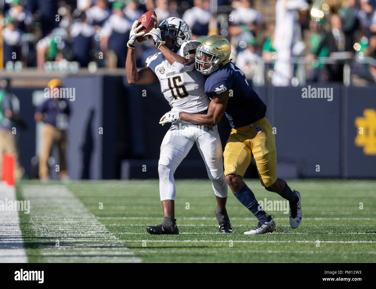 South Bend, Indiana, USA. 15th Sep, 2018. Vanderbilt wide receiver Kalija Lipscomb (16) makes the catch as Notre Dame defensive back Troy Pride Jr. (5) defends during NCAA football game action between the Vanderbilt Commodores and the Notre Dame Fighting Irish at Notre Dame Stadium in South Bend, Indiana. Notre Dame defeated Vanderbilt 22-17. John Mersits/CSM/Alamy Live News Stock Photo