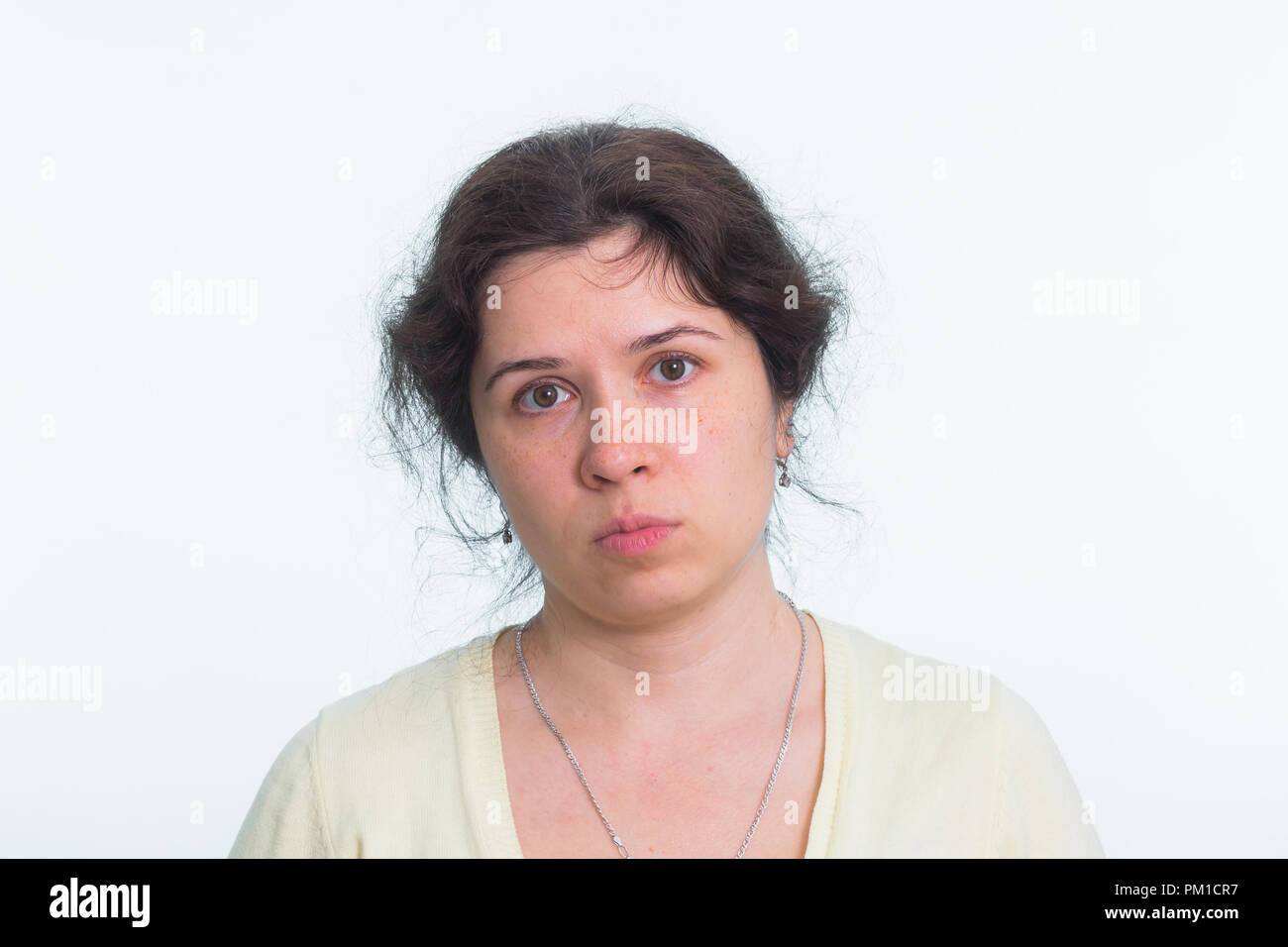 Portrait of sad woman standing on white background Stock Photo - Alamy