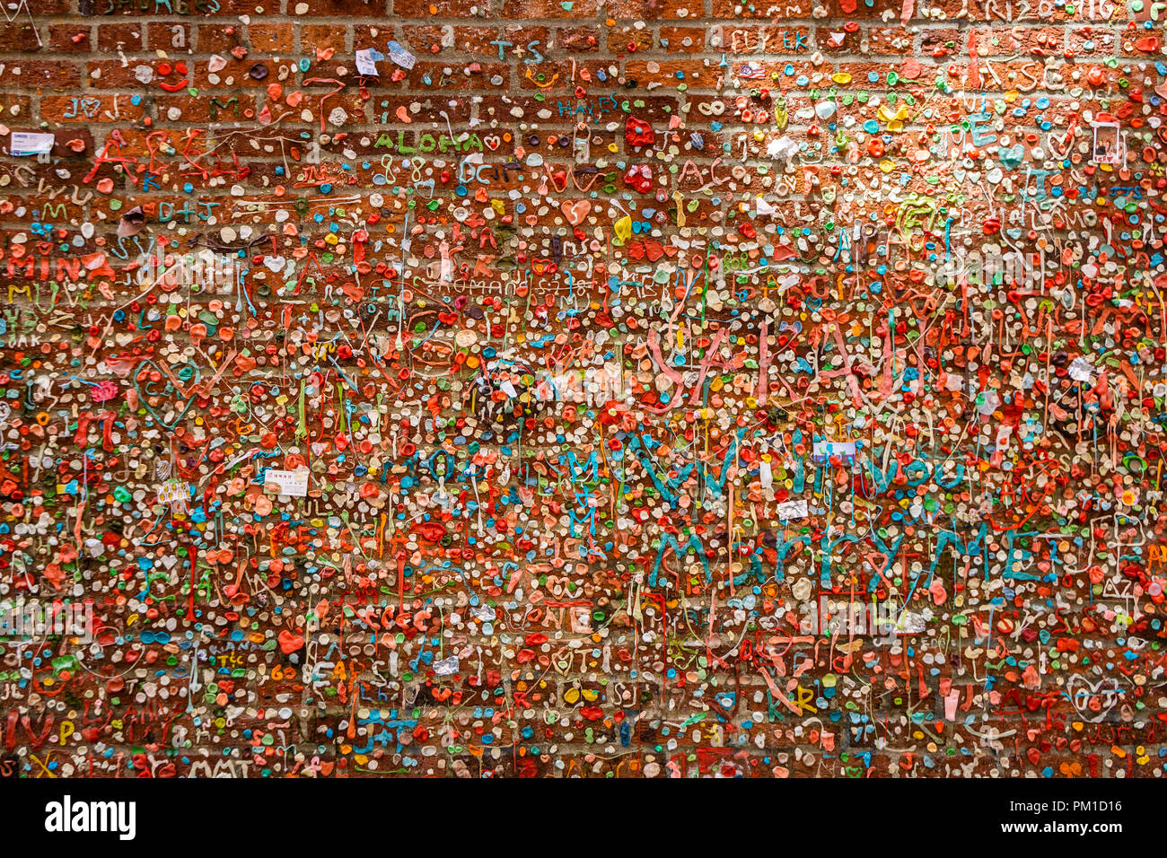 Gum Wall Market Theater in Post Alley, under Pike Place Market. Brick Wall covered with used chewing gums, downtown Seattle, WA, USA. Stock Photo