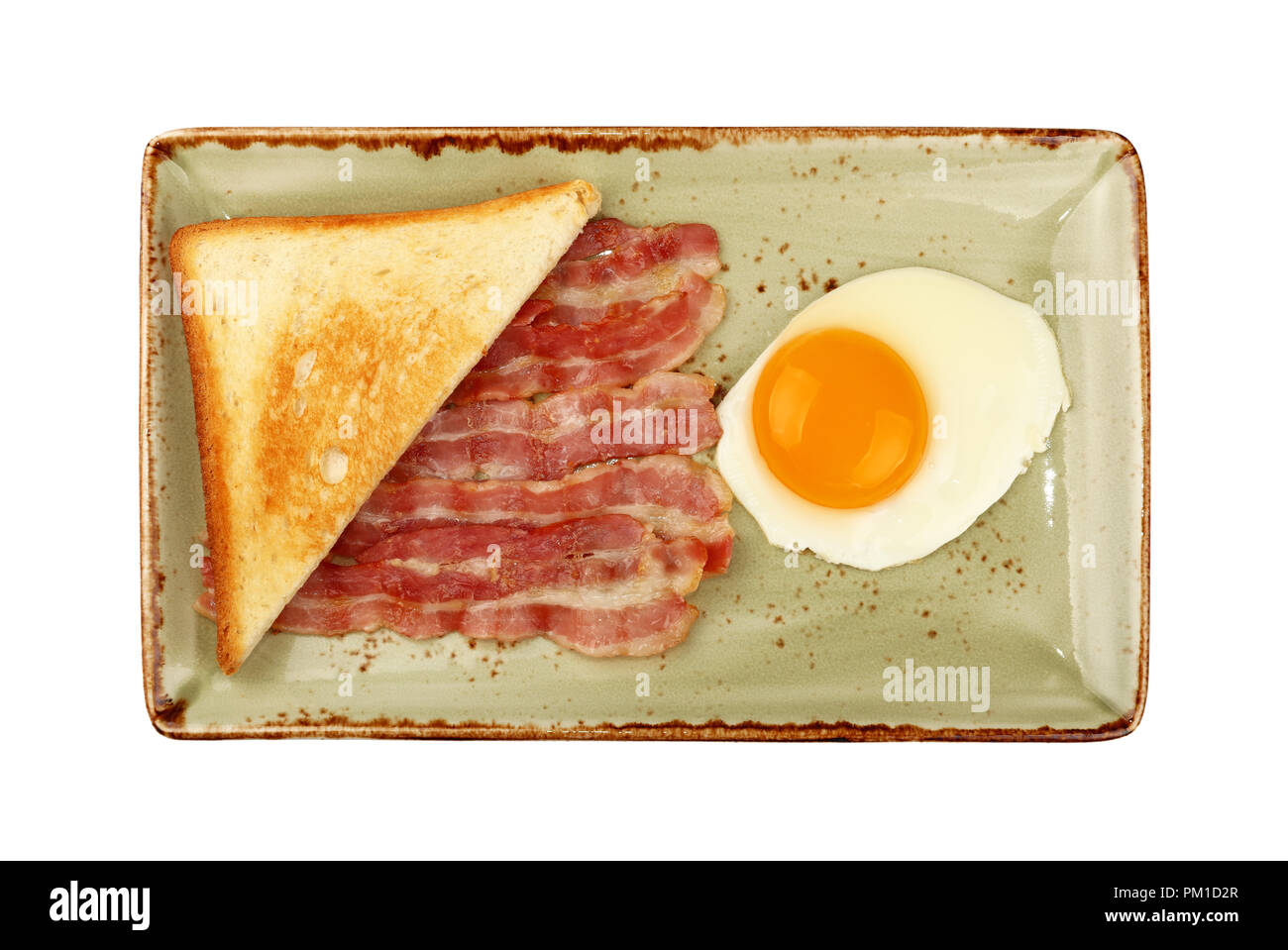 Close up English breakfast, sunny side egg, half of toasted bread and roasted bacon slices on blue plate isolated on white background, elevated top vi Stock Photo
