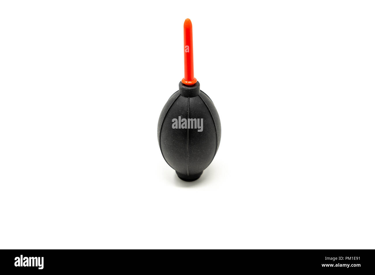 A DSLR dust blower with a black bulb and red nozzle isolated against a