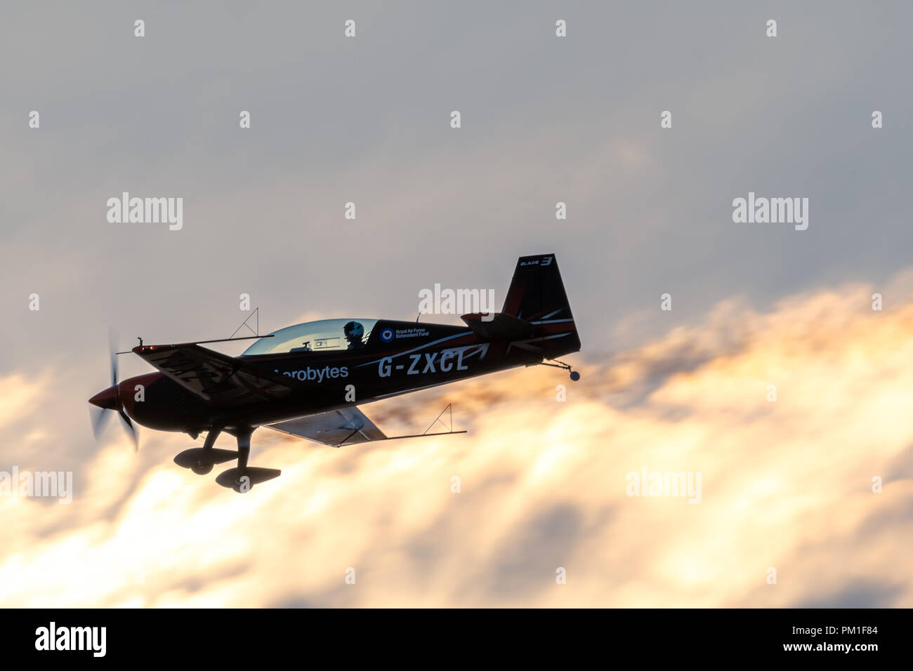 SOUTHPORT, UK JULY 6 2018:  A photograph documenting The Blades Aerobatic Display Team performing at dusk, flying into the setting sun, at the annual  Stock Photo