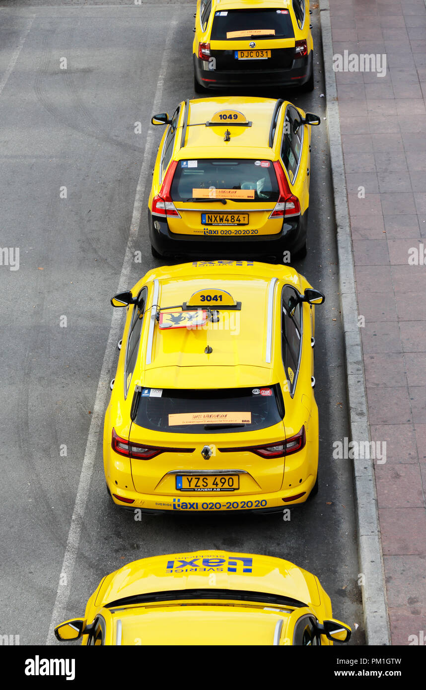 Stockholm, Sweden - September 13, 2018: Yellow taxicabs in service for Sverige Taxi  lined up at the taxicab rank at the Stockholm central station. Stock Photo