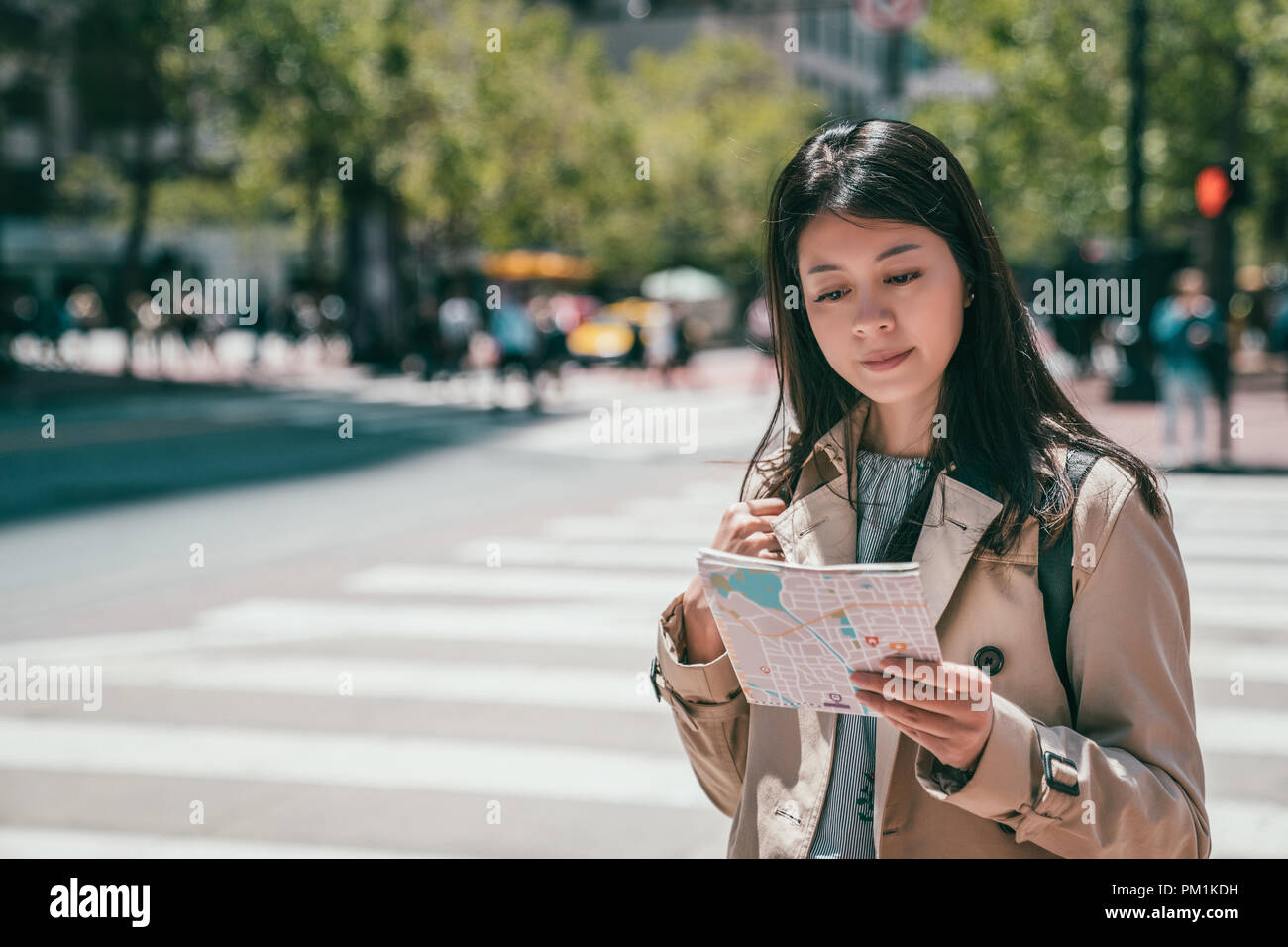 Woman Reading A Guide pretty asian woman reading a guide map in streets and searching for the ...