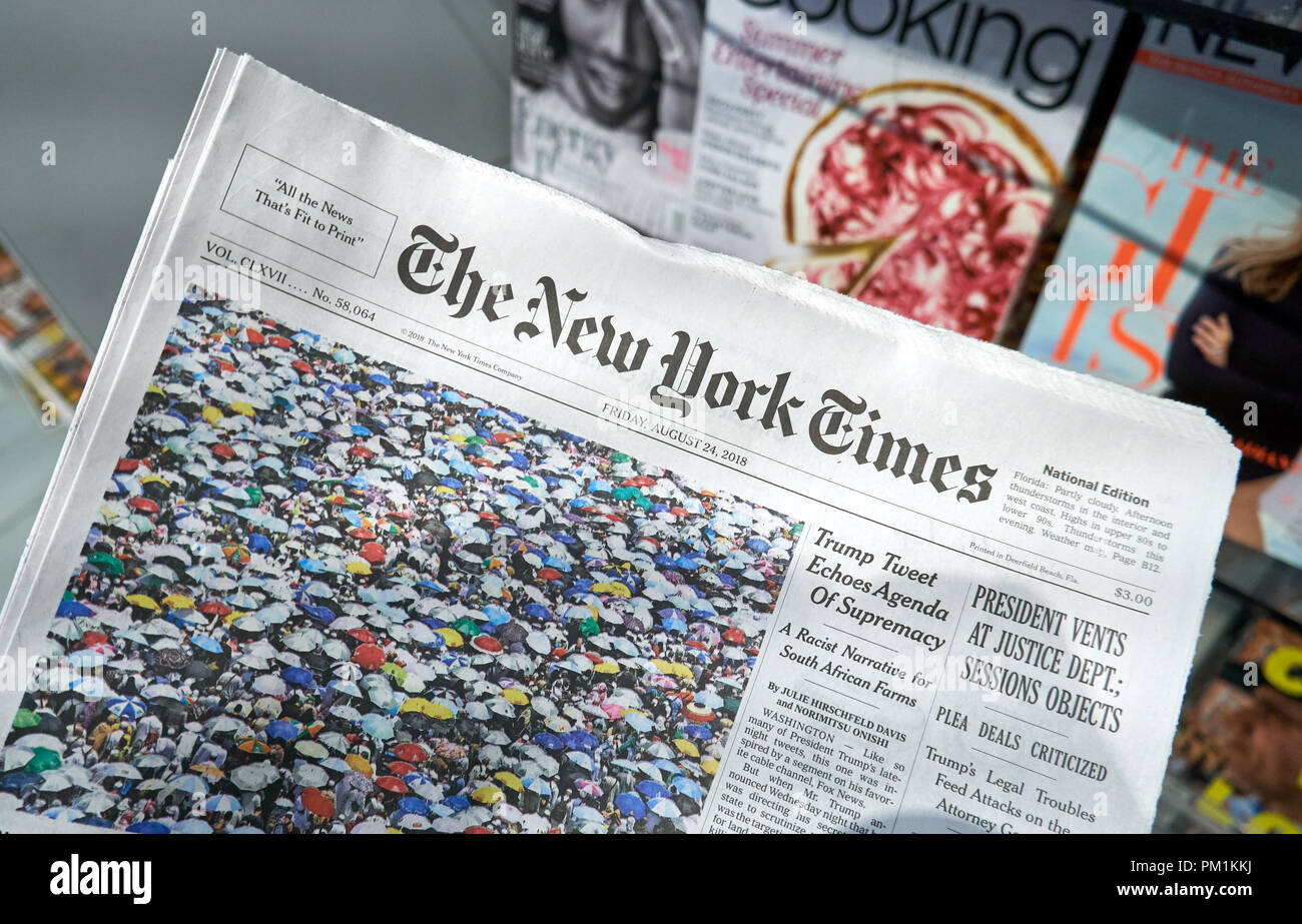 MIAMI, USA - AUGUST 22, 2018: The New York Times newspaper in a hand. The New York Times is a popular American newspaper based in New York City with w Stock Photo