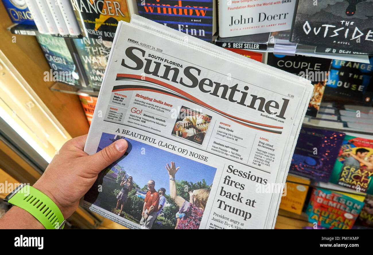 MIAMI, USA - AUGUST 22, 2018: The Sun-Sentinel newspaper in a hand. The Sun-Sentinel is the main daily newspaper of Fort Lauderdale, Florida. Stock Photo