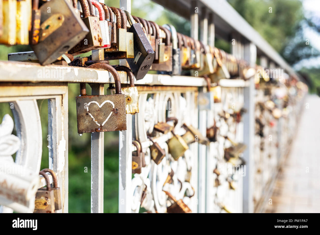 Red heart padlock locked on fence. Lock in shape of heart as symbol of ...