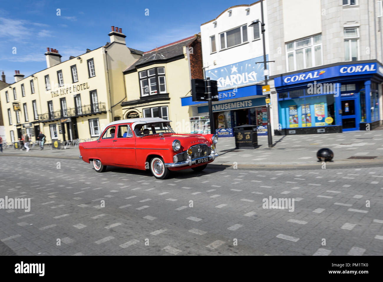 Classic Ford Zephyr saloon car driving along Marine Parade, Southend on Sea, Essex, seafront. Stardust amusements. Red vehicle Stock Photo