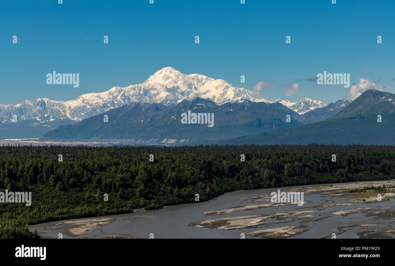 View of Denali (formerly Mount McKinley) and the Nenana River against a blue sky in summertime. Tallest mountain in North America, Alaska, USA. Stock Photo