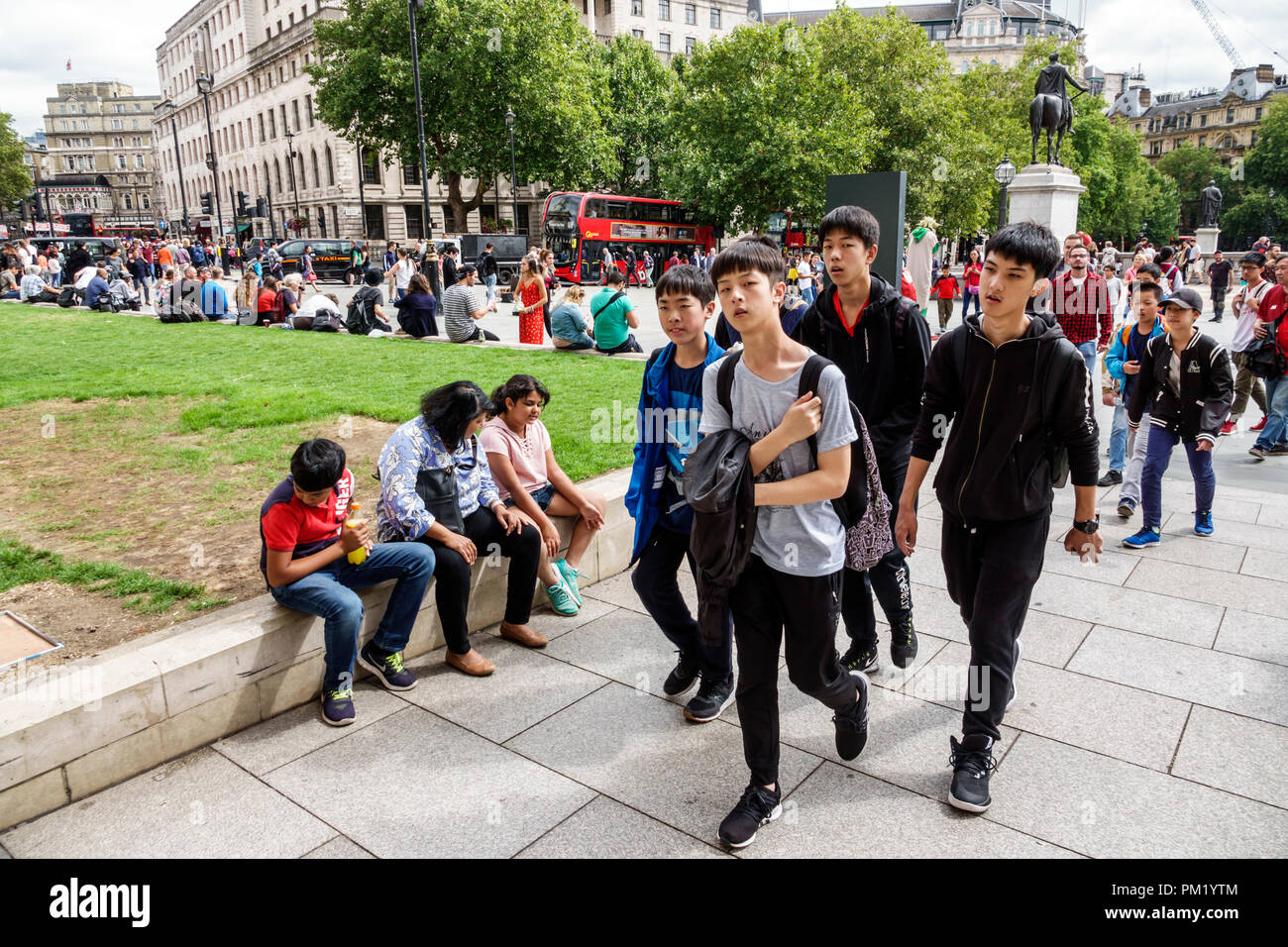 London England,UK,United Kingdom Great Britain,Trafalgar Square,plaza,crowd,Asian Asians ethnic immigrant immigrants minority,boy boys,male kid kids c Stock Photo