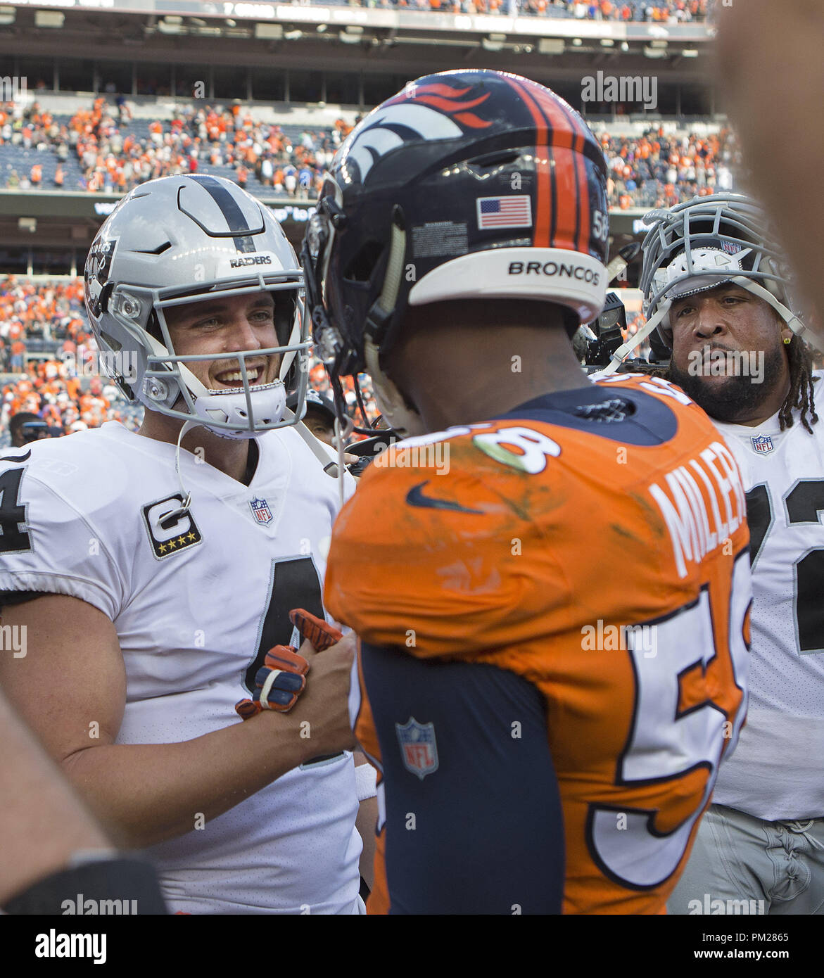 Denver, Colorado, USA. 16th Sep, 2018. Raiders QB DEREK CARR, left, shakes hands with Broncos OLB VON MILLER, right, after the game at Broncos Stadium at Mile High Sunday afternoon. The Broncos beat the Raiders 20-19. Credit: Hector Acevedo/ZUMA Wire/Alamy Live News Stock Photo