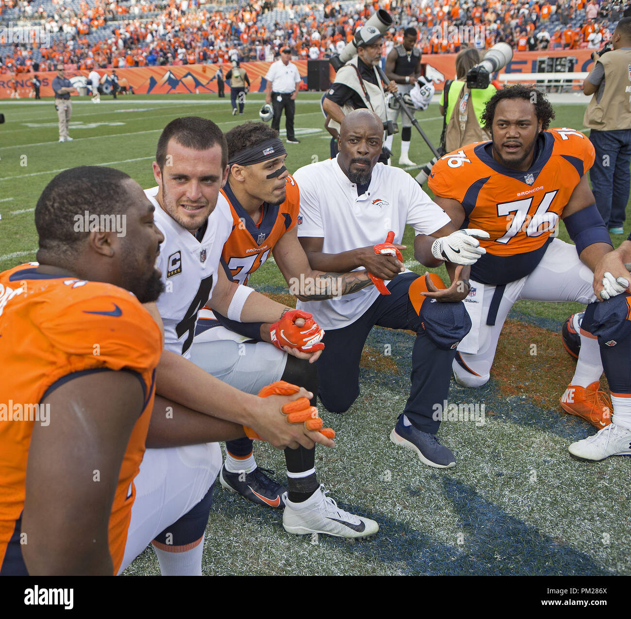 Denver, Colorado, USA. 16th Sep, 2018. Raiders QB DEREK CARR, second from the left, readies to pray with other Broncos and Raiders after the game at Broncos Stadium at Mile High Sunday afternoon. The Broncos beat the Raiders 20-19. Credit: Hector Acevedo/ZUMA Wire/Alamy Live News Stock Photo