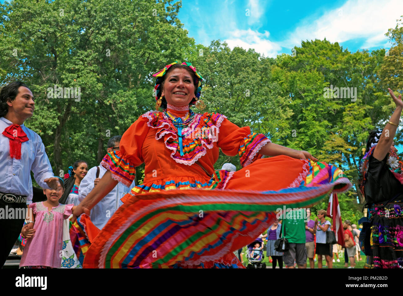 Cleveland, Ohio, USA.  16th Sept, 2018.  A woman of Mexican heritage takes part in the Parade of Flags as part of the 73rd Annual One World Day celebration in Cleveland, Ohio, USA.  Dozens of ethnic communities found throughout the Cleveland, Ohio, USA area come together each year for a celebration of diversity, cross-cultural learning, ethnic pride, and community.  The event is held in the Cultural Gardens of Rockefeller Park in which dozens of ethnic communities that have immigrated to Northeast Ohio maintain gardens representing their cultural heritage. Credit: Mark Kanning/Alamy Live News Stock Photo