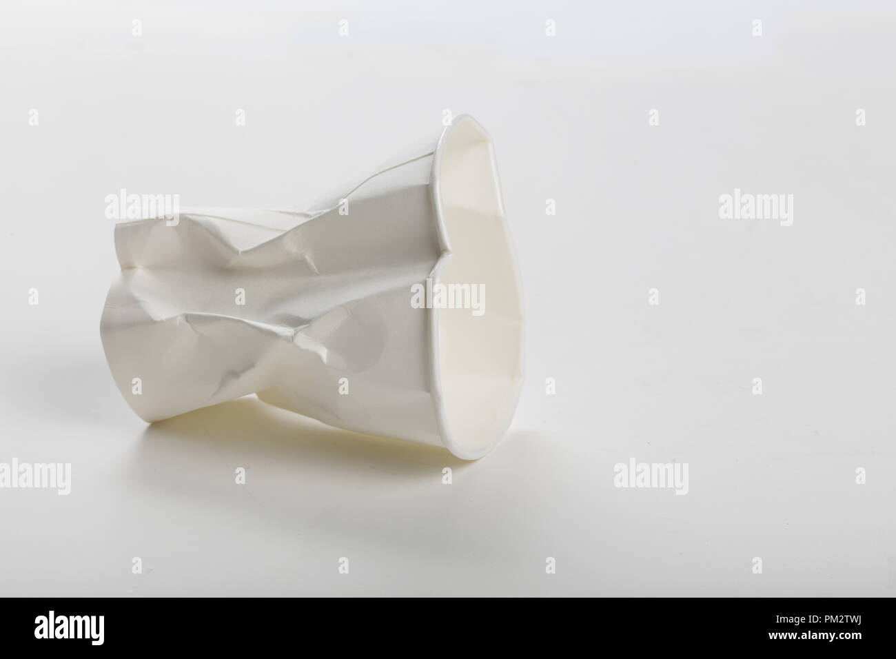 Crumbled White paper coffee cup on white background Stock Photo - Alamy