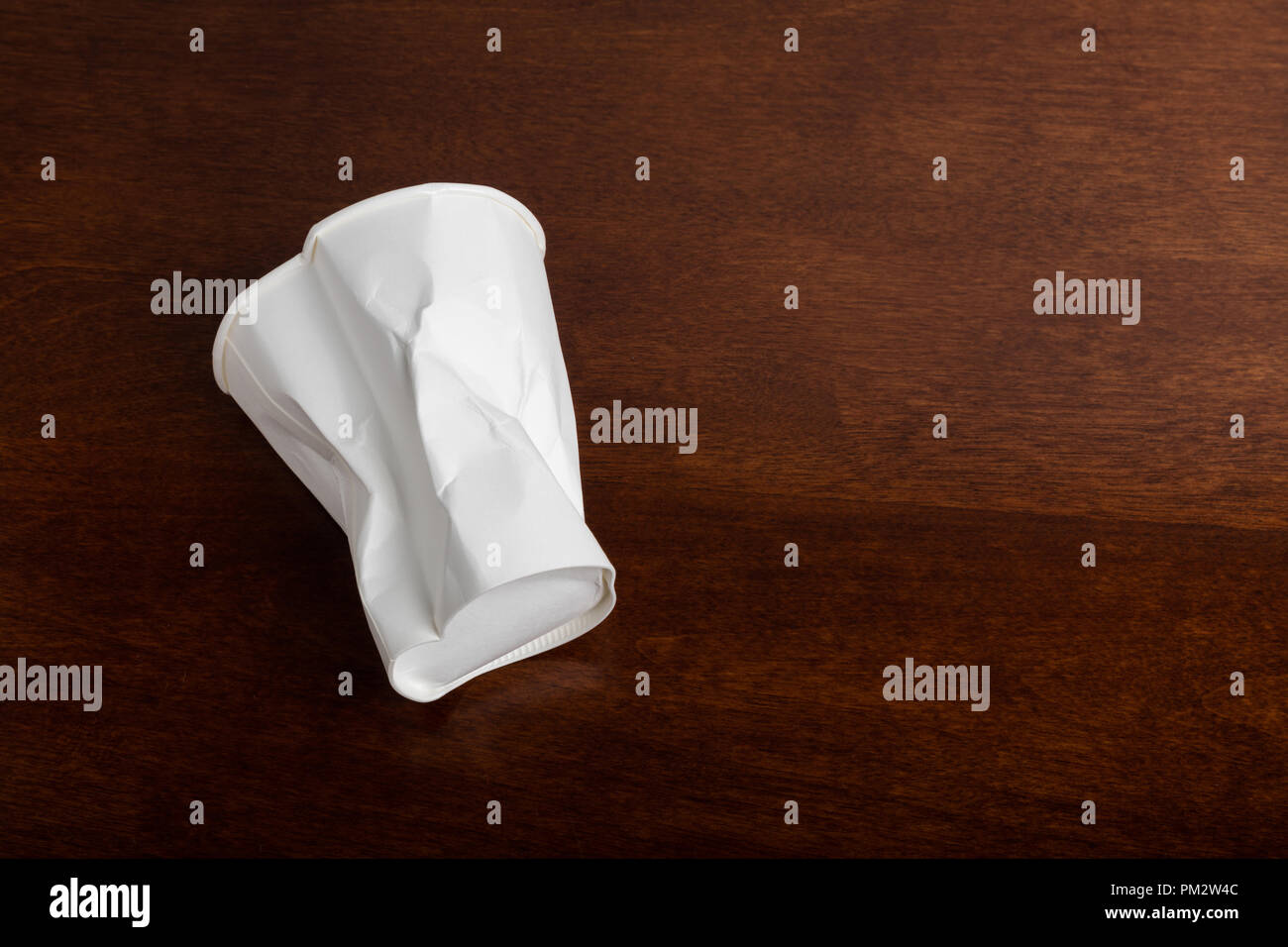 Crumbled White paper coffee cup on table Stock Photo - Alamy