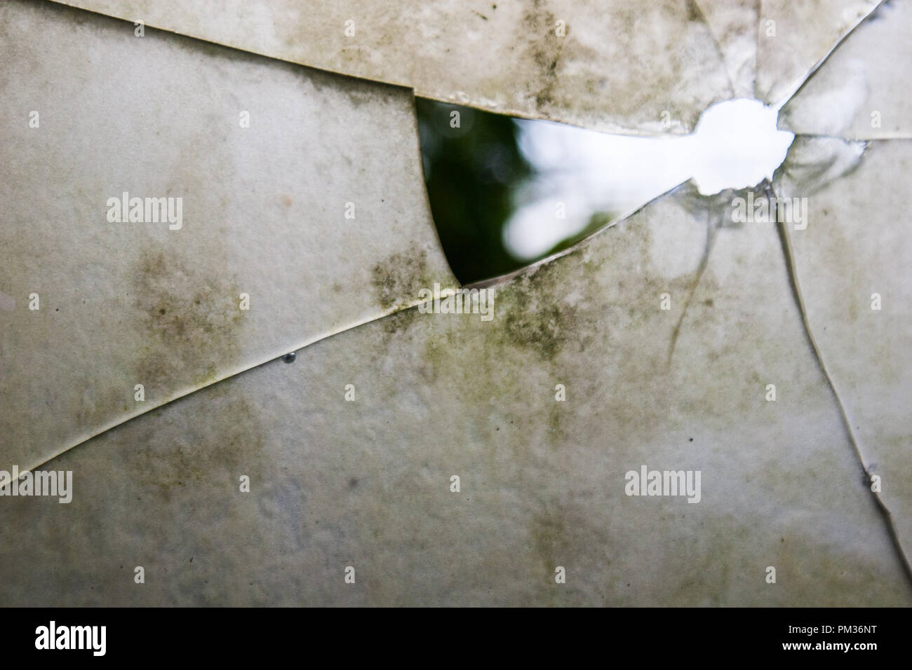 Wallpaper Background Of Broken White Glass With A Hole From Where The Nature Of The Landscape Can Be Seen No People Stock Photo Alamy