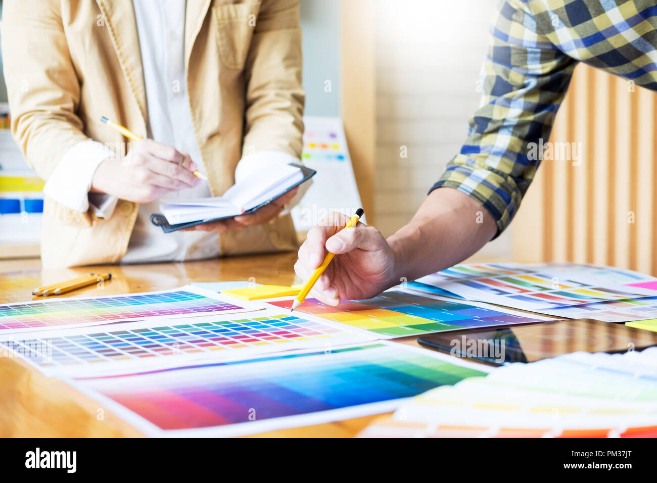 atwork office interiors bakers creative graphic designer at work color swatch samples pantone palette in studio modern office interior design renovation and technology concept atwork office interiors bakers creative graphic designer at work color swatch samples pantone palette in studio modern office interior design renovation and technology concept