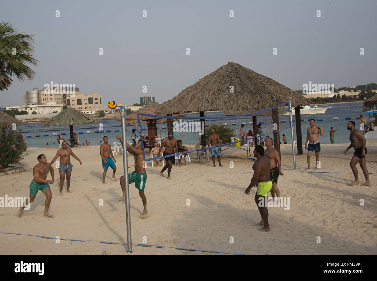 group of men playing volley ball at a private beach in Jeddah, Saudi Arabia Stock Photo