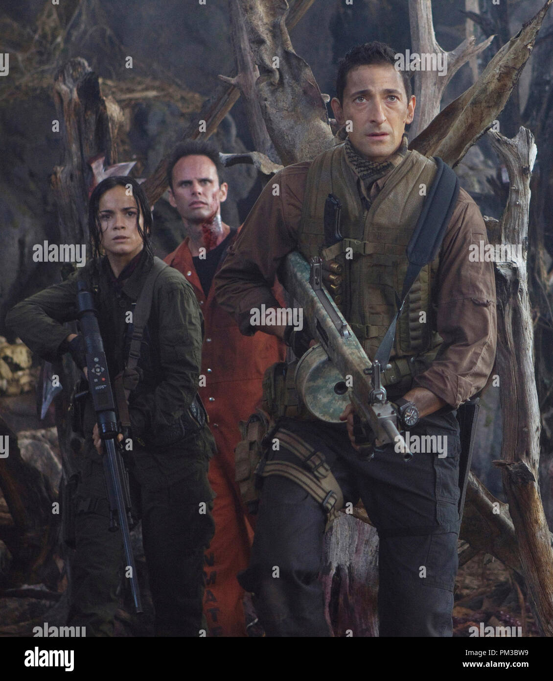 (left-right) Isabelle (Alice Braga), Stans (Walton Goggins) and Royce (Adrien Brody) face a fearsome enemy. Stock Photo