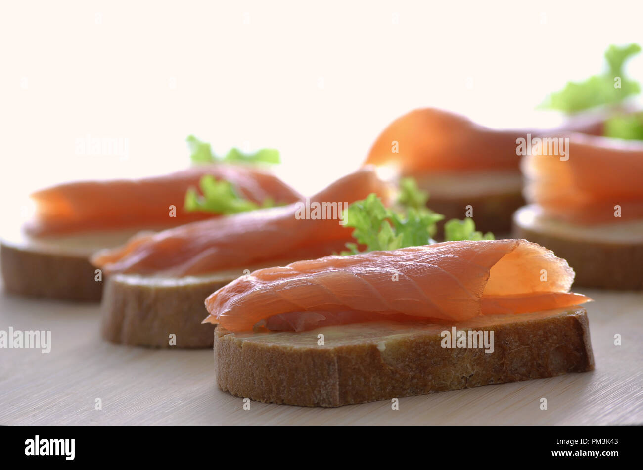 Canapes with smoked salmon, butter and lettuce leaf. Shallow dof Stock