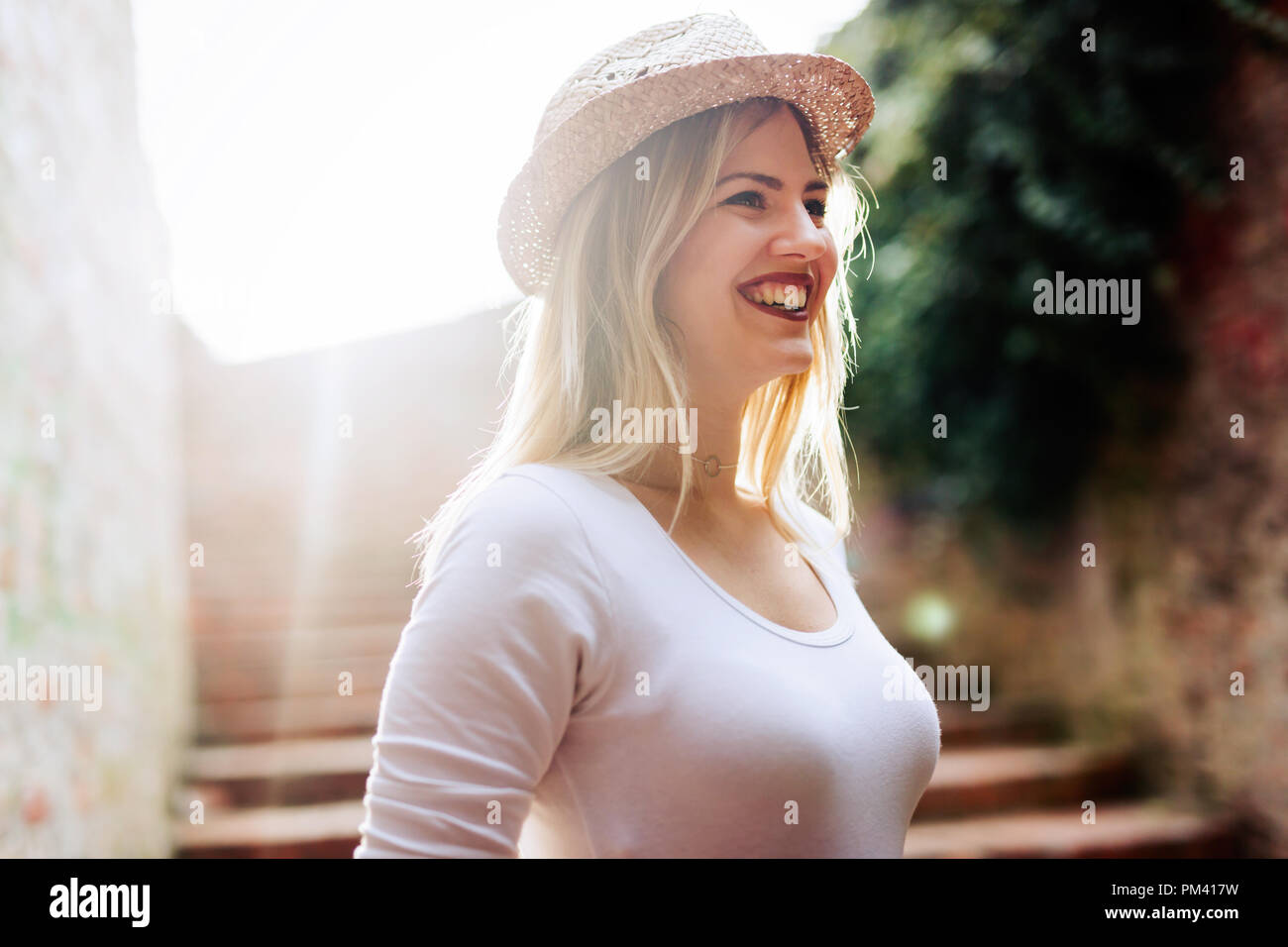 Happy young blond female wearing hat outdoor Stock Photo