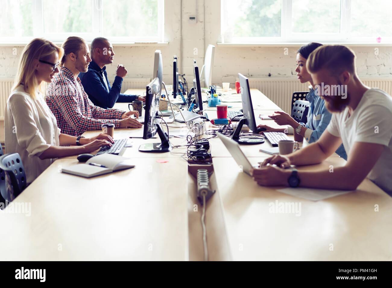 Just working day. Young modern colleagues in smart casual wear working