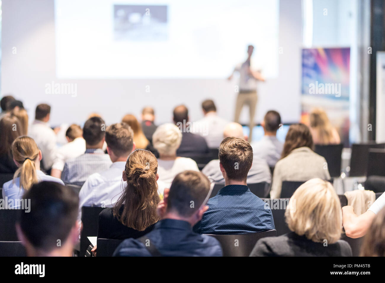 Speaker giving a talk in conference hall at business event. Audience at the conference hall. Business and Entrepreneurship concept. Focus on unrecogni Stock Photo